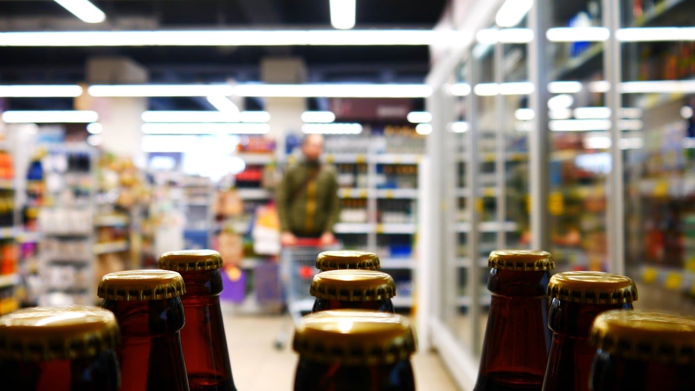 Shoppers browsing snacks and drinks in an elevated convenience store